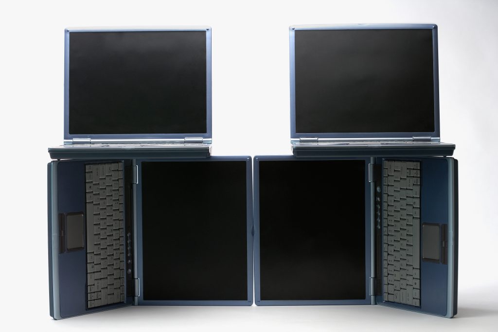Arrangement of four open laptop computers electronics lifespan